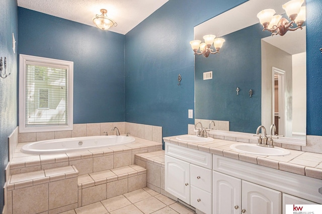 bathroom featuring vanity, tiled tub, tile patterned flooring, and a notable chandelier