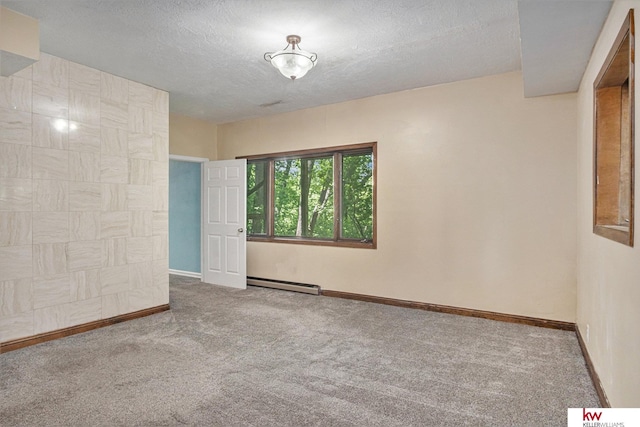 unfurnished room featuring baseboard heating, carpet floors, and a textured ceiling