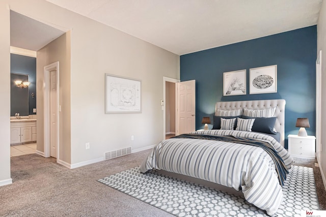 carpeted bedroom featuring connected bathroom and sink