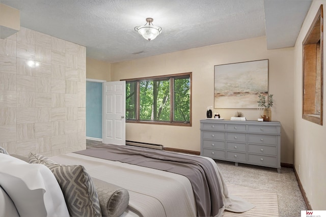 bedroom featuring a baseboard radiator, carpet, and a textured ceiling