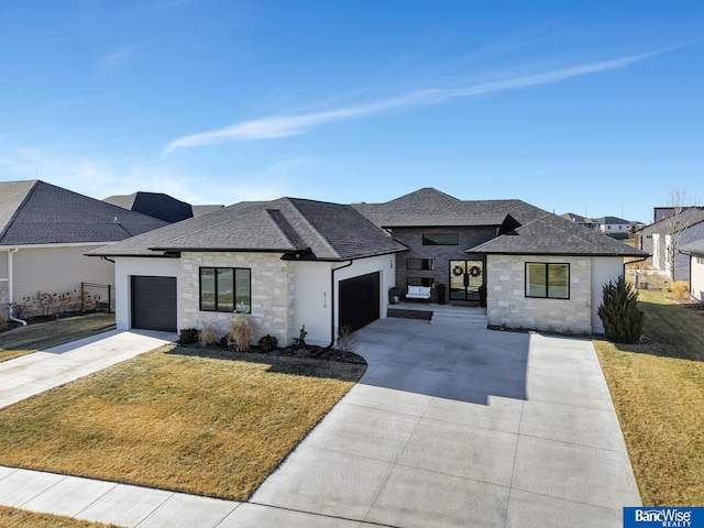 view of front of home featuring a garage and a front yard