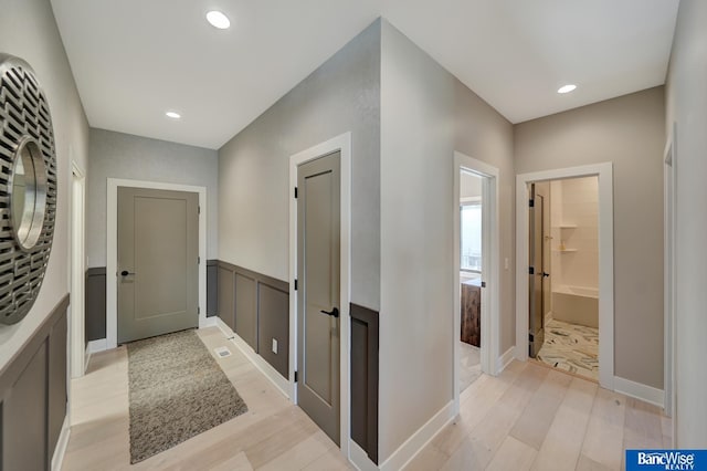 hall with light hardwood / wood-style floors