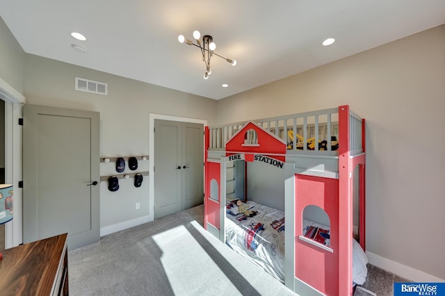 bedroom featuring light colored carpet and a closet