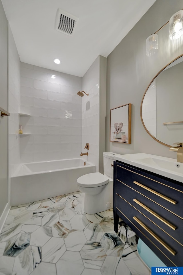 full bathroom featuring vanity, toilet, and tiled shower / bath