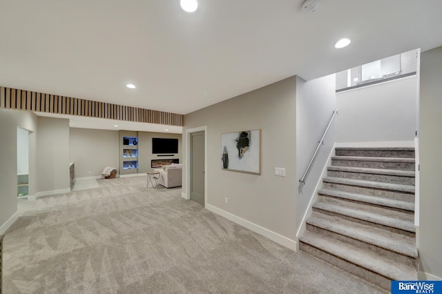 basement featuring light carpet