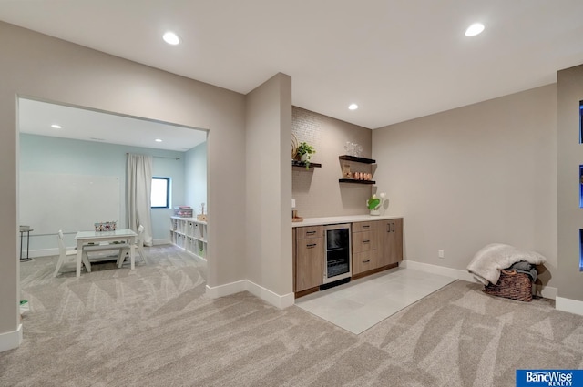 bar with wine cooler and light carpet