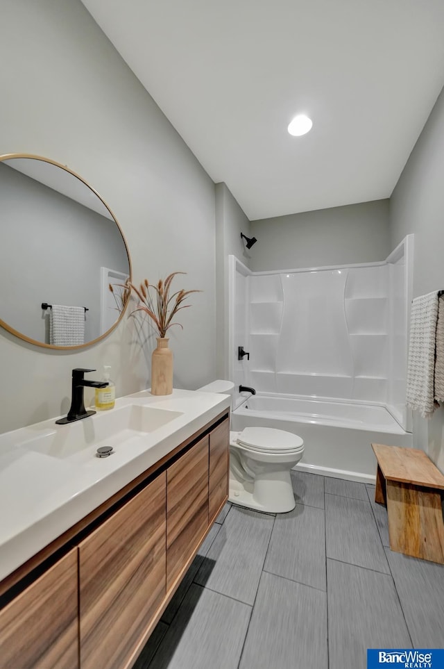 full bathroom featuring vanity, tub / shower combination, and toilet