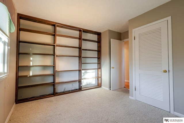 unfurnished bedroom featuring light carpet