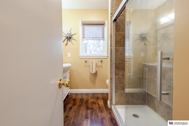 bathroom featuring vanity, toilet, an enclosed shower, and hardwood / wood-style floors