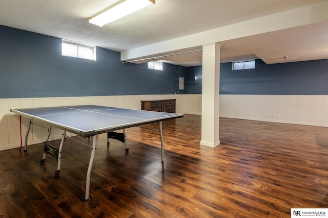 recreation room with dark hardwood / wood-style floors and a textured ceiling