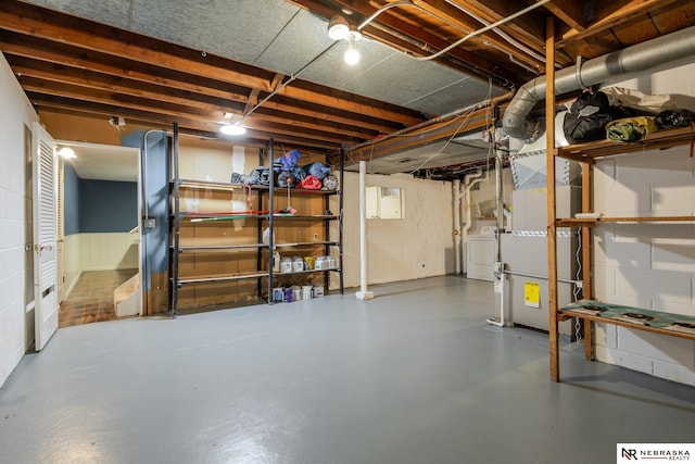 basement with heating unit and washer / dryer