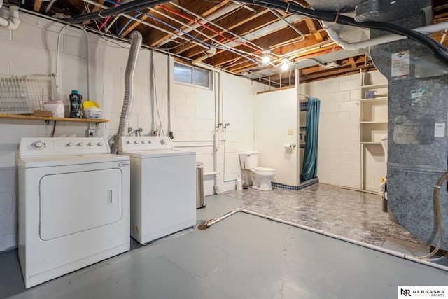 basement featuring heating unit and independent washer and dryer