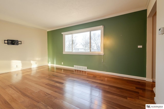 unfurnished room with crown molding and hardwood / wood-style floors