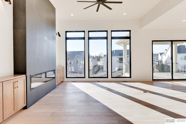 interior space with ceiling fan and light wood-type flooring