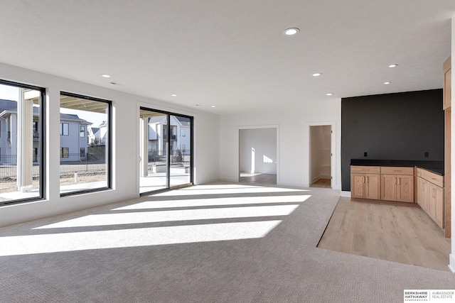 unfurnished living room with light wood-type flooring