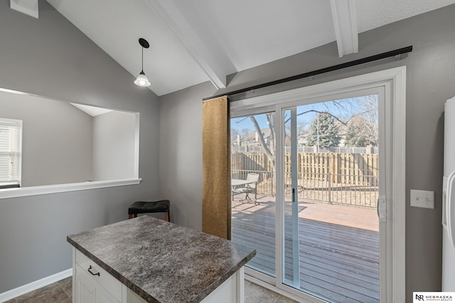 entryway with vaulted ceiling with beams