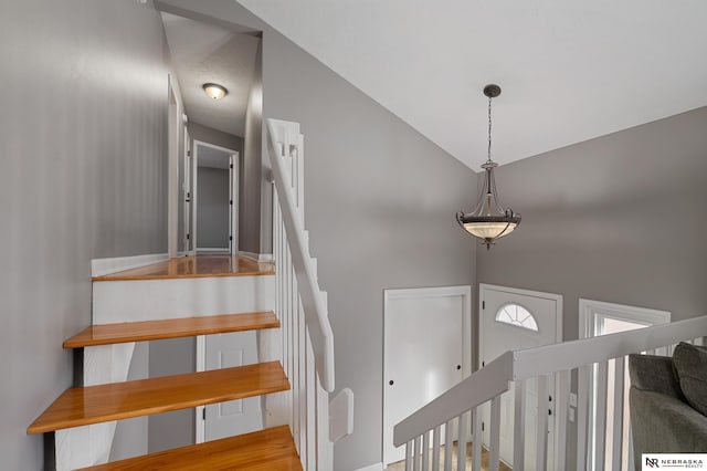 stairway featuring lofted ceiling