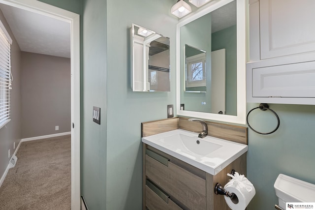 bathroom featuring vanity and toilet