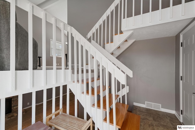 stairway featuring tile patterned floors