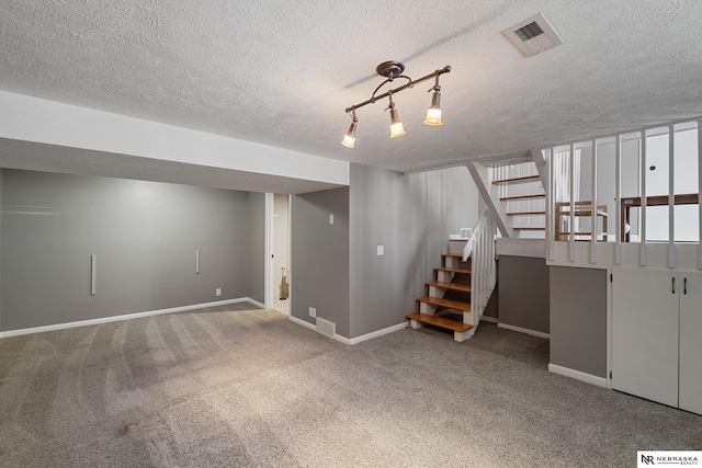 basement with carpet floors and a textured ceiling