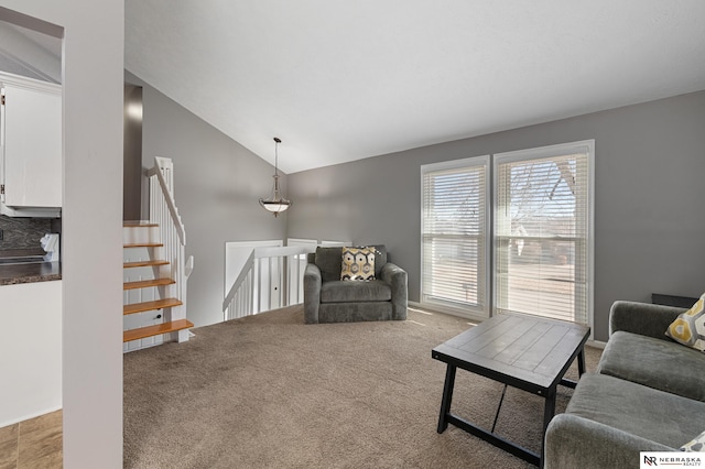 living room featuring carpet floors and vaulted ceiling