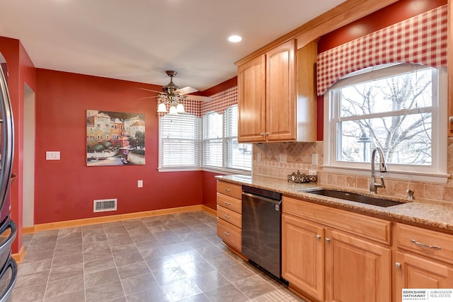 kitchen with sink, dishwasher, ceiling fan, tasteful backsplash, and light stone counters