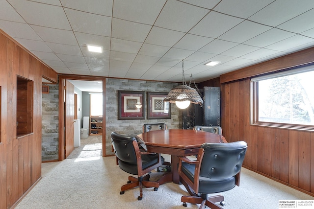 office space featuring light carpet and wooden walls