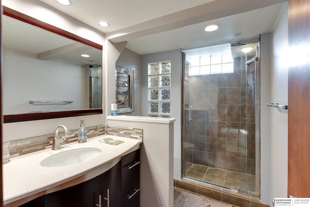 bathroom with vanity and a shower with shower door