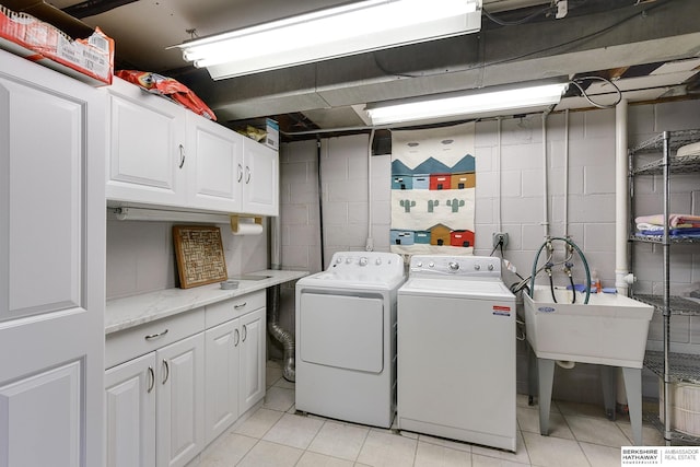 washroom with independent washer and dryer and cabinets