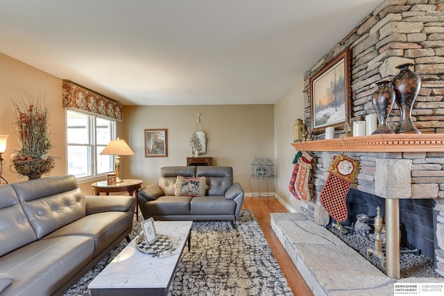 living room with hardwood / wood-style floors and a fireplace