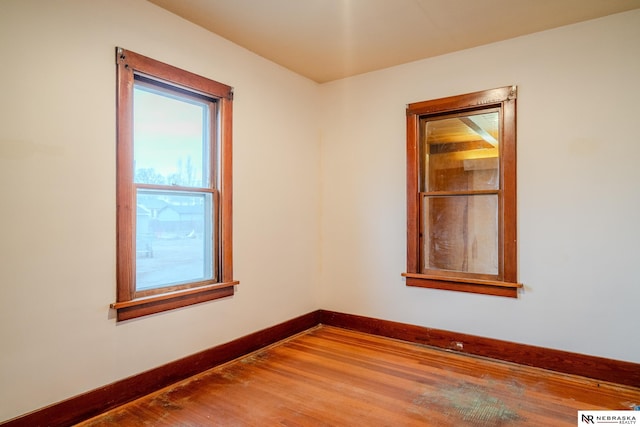 unfurnished room with hardwood / wood-style floors