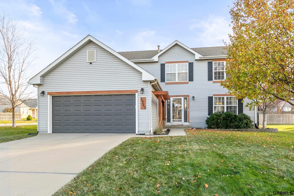 view of front of home with a garage and a front yard