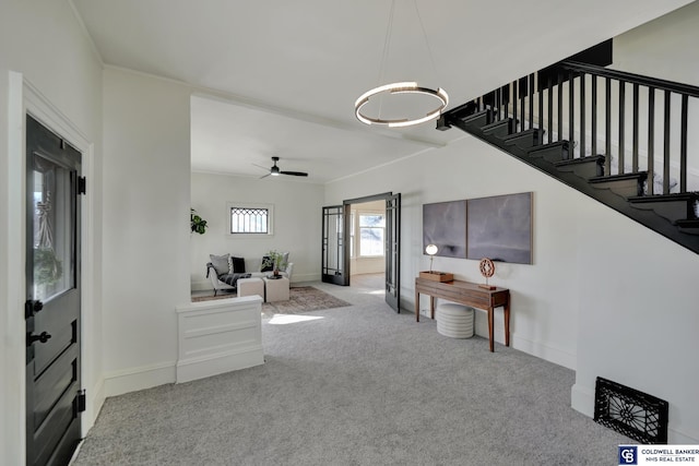 interior space with crown molding, carpet floors, and ceiling fan