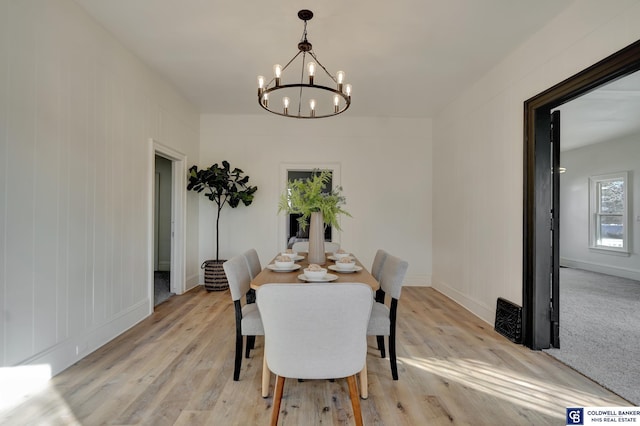 dining room with an inviting chandelier and light hardwood / wood-style floors