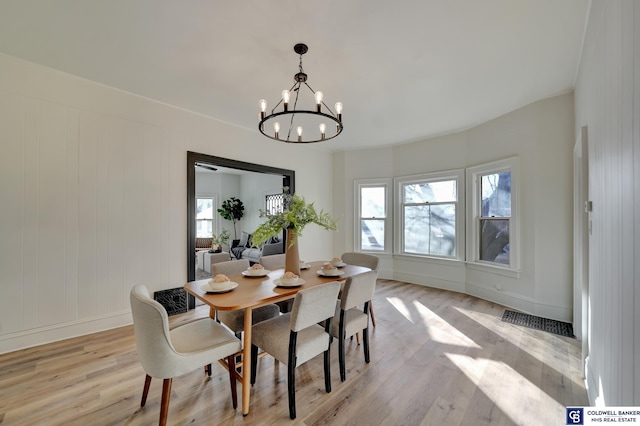 dining room featuring a chandelier and light hardwood / wood-style flooring