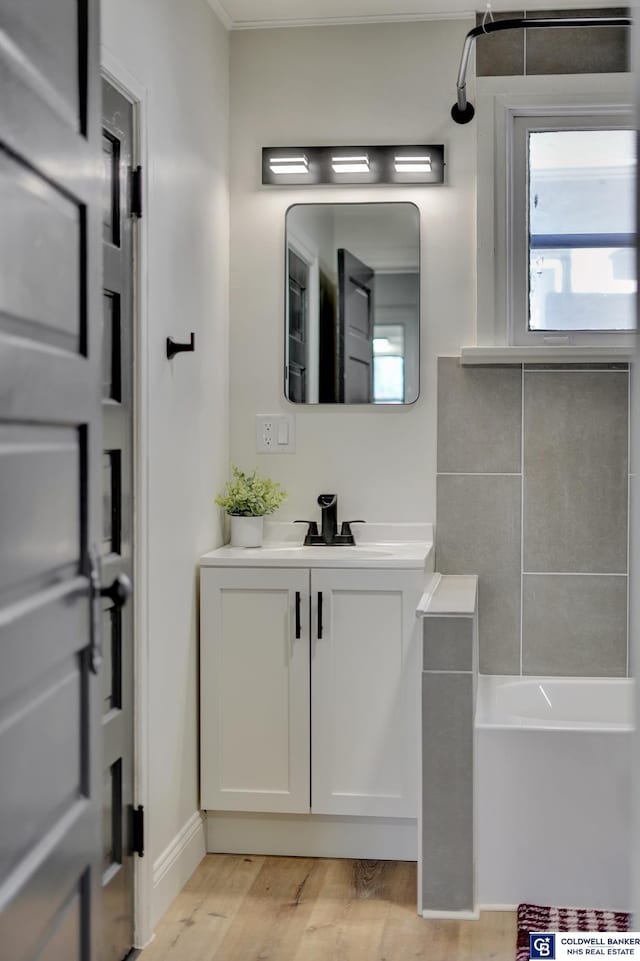 bathroom with vanity, wood-type flooring, and shower / bathing tub combination