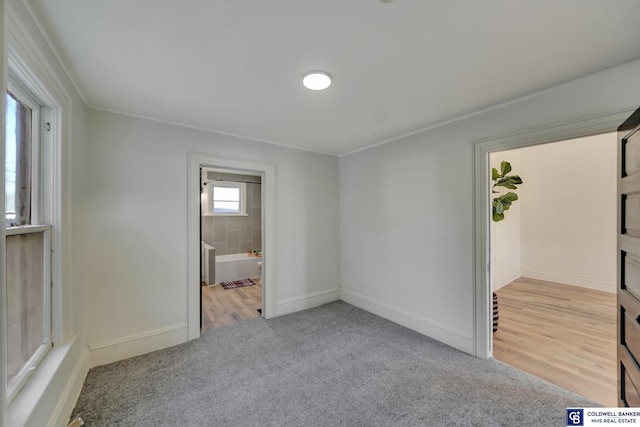 carpeted empty room featuring ornamental molding