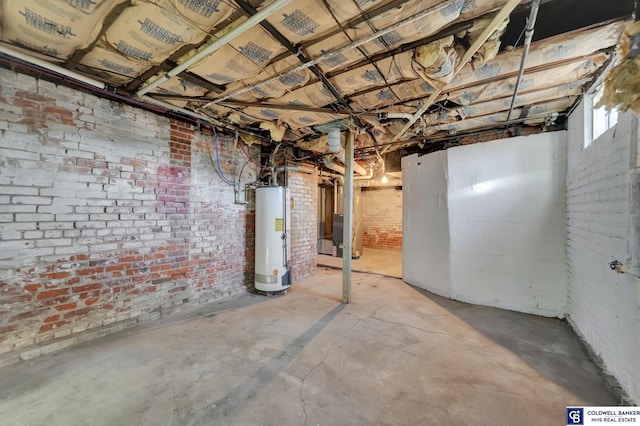 basement featuring brick wall and gas water heater