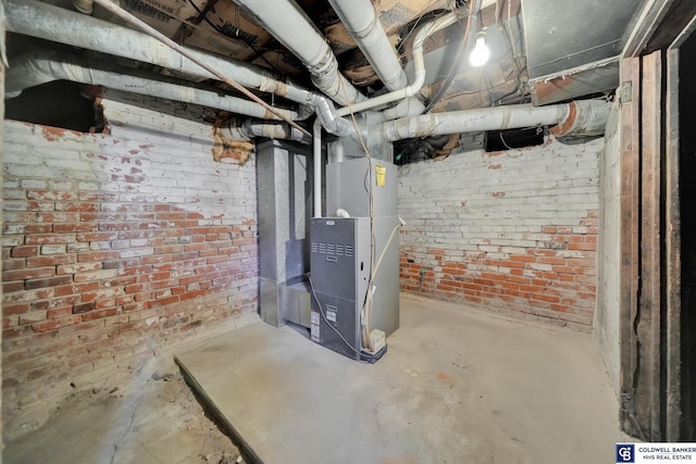 basement with brick wall and heating unit