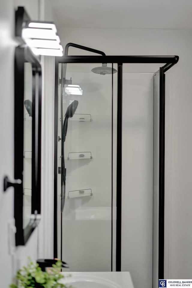 bathroom featuring a shower with door