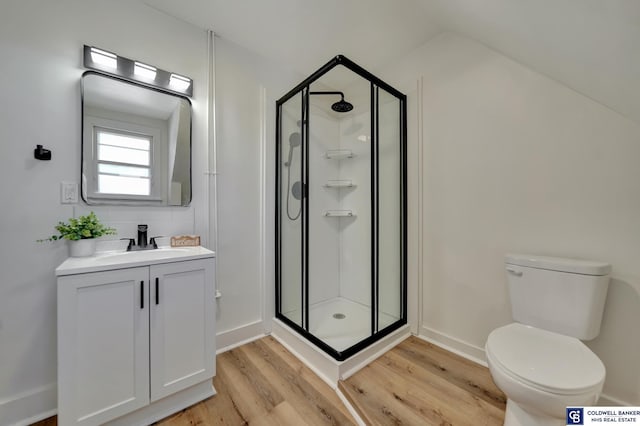 bathroom with a shower with door, vanity, hardwood / wood-style flooring, and toilet