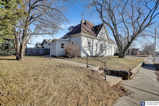 view of side of property featuring a yard