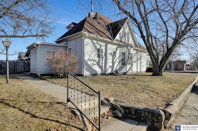 view of side of home featuring a lawn