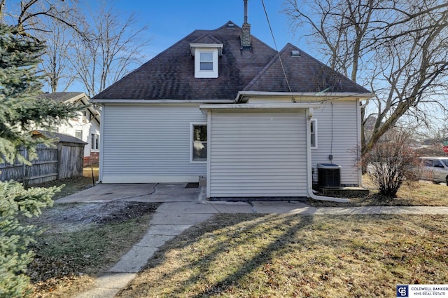 back of property featuring a patio, a yard, and central AC