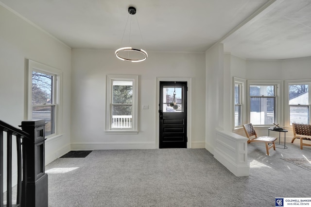 entryway with a wealth of natural light and carpet flooring