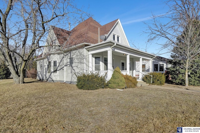 view of front of house with a porch and a front yard