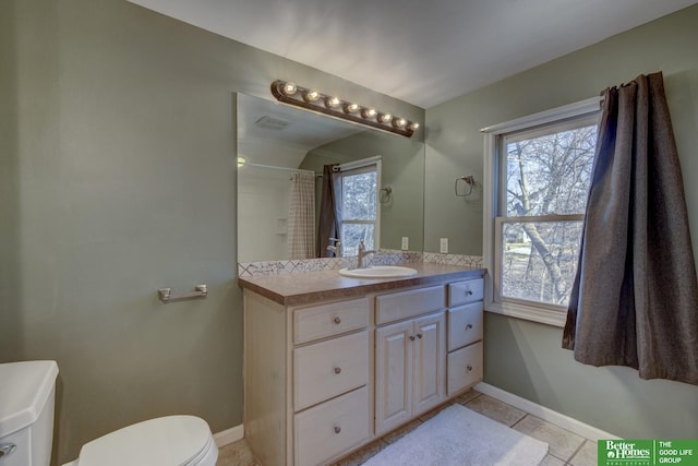 bathroom featuring a shower with curtain, vanity, toilet, and a wealth of natural light