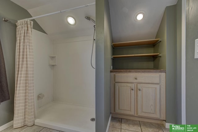 bathroom featuring walk in shower, tile patterned floors, vaulted ceiling, and ornate columns