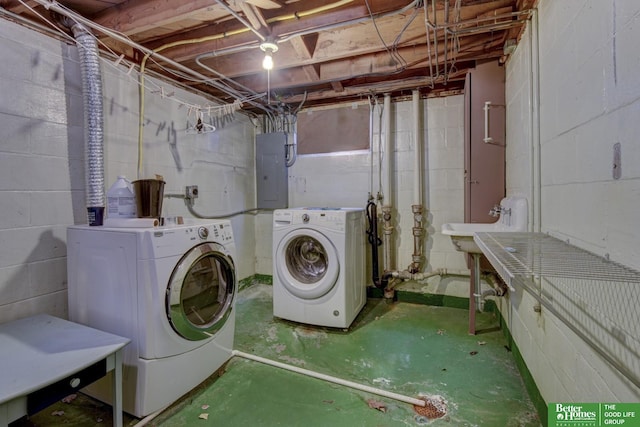 washroom featuring separate washer and dryer, sink, and electric panel