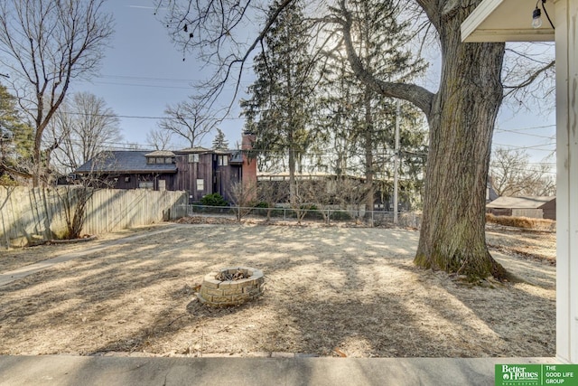 view of yard with a fire pit